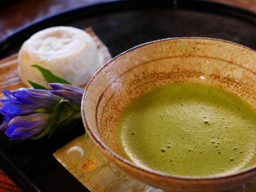 Traditional Japanese matcha served with wagashi sweets, showcasing cultural rituals that shaped A History On Tea. The Japanese prefer their tea green, dried then powdered to make the popular Matcha tea.