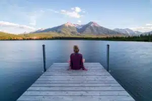 Woman seeking solitude in nature, a peaceful escape from emotional burnout symptoms.