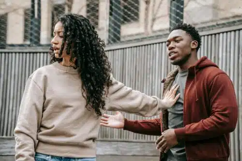 A couple arguing outdoors, showing conflict and tension in a relationship — a visual for “Is Your Partner Echoing Your Parent?” and the patterns we repeat in love.