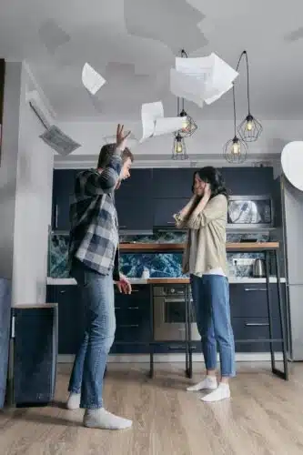 Man yelling and throwing papers while woman covers ears, capturing volatile communication—Is your partner echoing your parent?